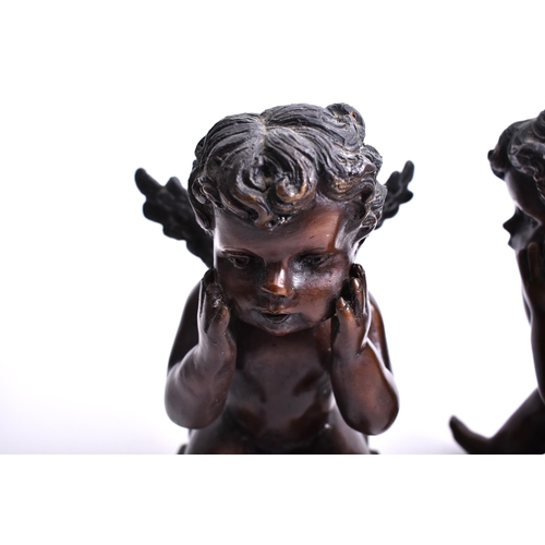 293 - A pair of early 20th century bronze cherub sculptures. Each of the cherubs seated on plinth base, wi... 