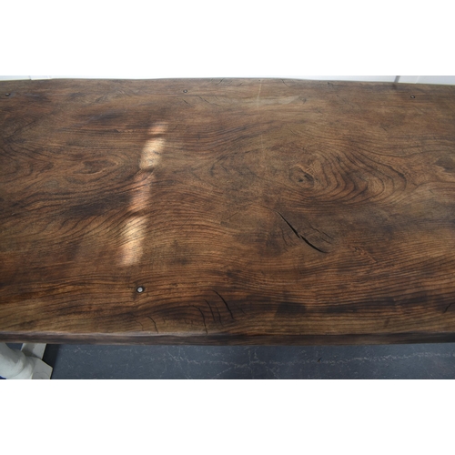 307 - A 19th century French continental elm wood refectory farmhouse dining table. The table having a sing... 