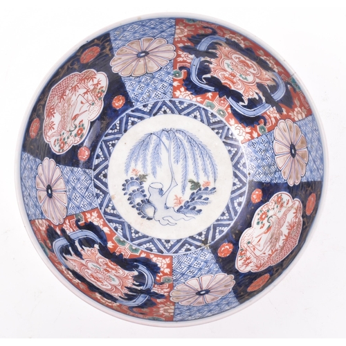 323 - A large early 20th century Meiji Japanese Imari pattern bowl / centrepiece. Hand painted with floral... 