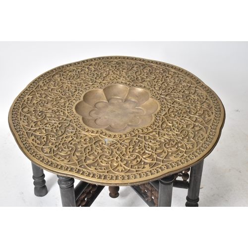 331 - A large early 20th century Indian Benares embossed brass & wooden side coffee table. The table havin... 