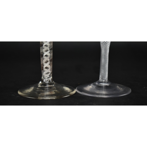 333 - Two 18th century wine glasses, each with a twist stem. One being a mid 18th century circa 1750 glass... 