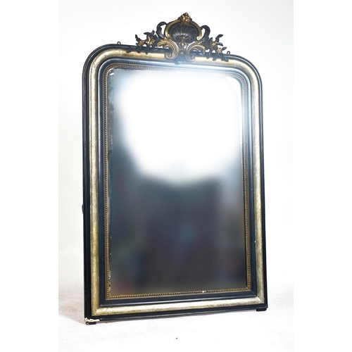 344 - A 19th century French Continental ebonised & silver gilt wood over mantel mirror. The overmantle mir... 