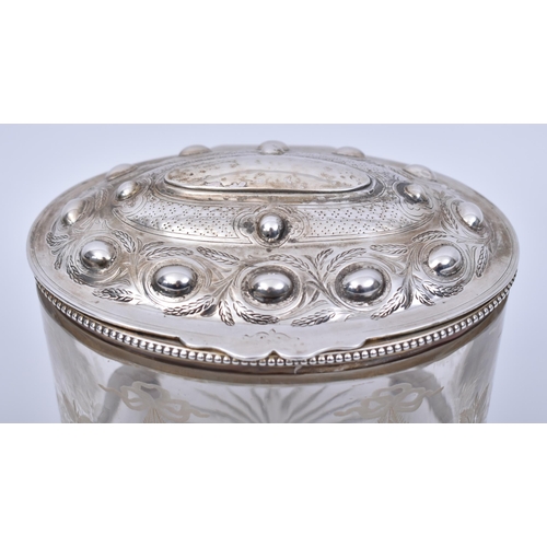 351 - A silver hallmarked and cut glass Bon Bon / biscuit box. Raised on bun feet with banded base, silver... 