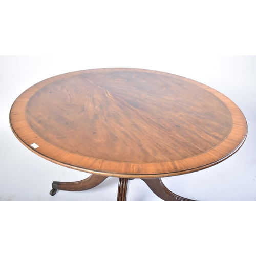 354 - A 19th century George III mahogany cross-banded breakfast table. Raised on reeded splayed legs to th... 