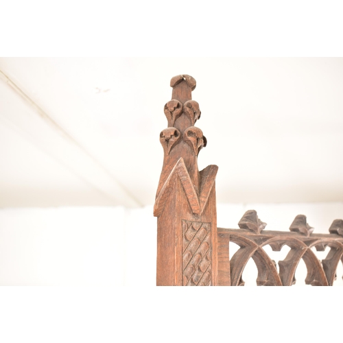 36 - A late 19th century Gothic oak church hall stand - coat stand. The carved fielded arched panel uprig... 