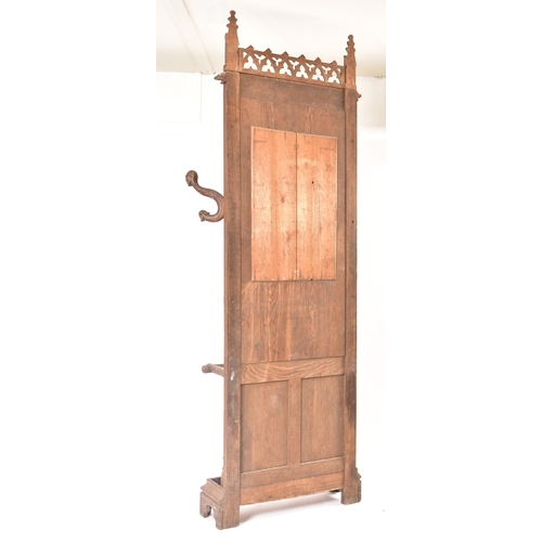 36 - A late 19th century Gothic oak church hall stand - coat stand. The carved fielded arched panel uprig... 