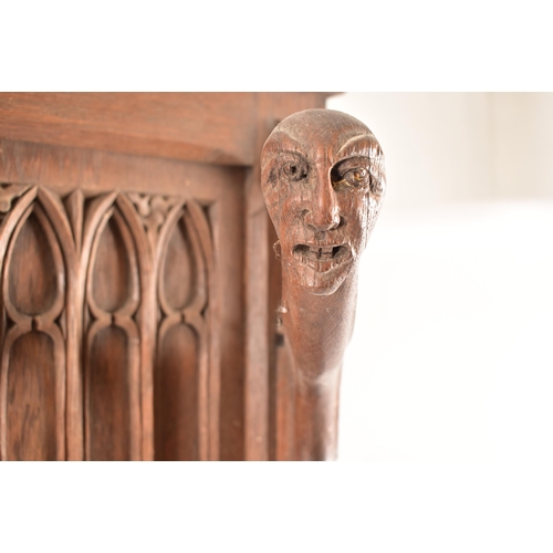 36 - A late 19th century Gothic oak church hall stand - coat stand. The carved fielded arched panel uprig... 