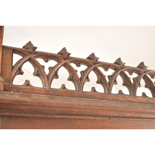 36 - A late 19th century Gothic oak church hall stand - coat stand. The carved fielded arched panel uprig... 