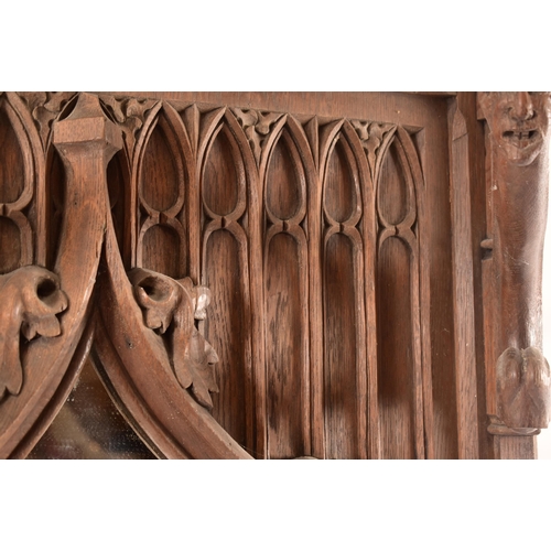 36 - A late 19th century Gothic oak church hall stand - coat stand. The carved fielded arched panel uprig... 