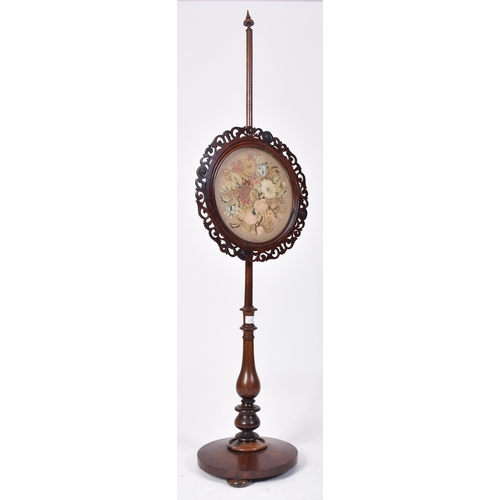 377 - A 19th century High Victorian mahogany pole screen. The terraced circular base with central pole hav... 