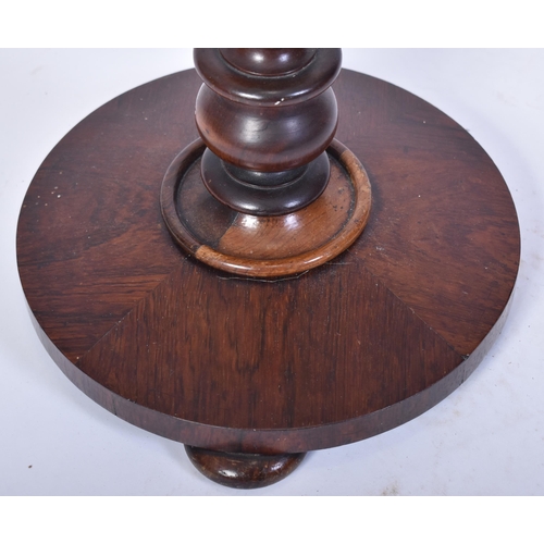 377 - A 19th century High Victorian mahogany pole screen. The terraced circular base with central pole hav... 