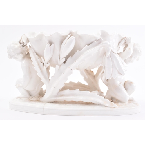 389 - A 19th century blanc de chine figural group centrepieces by Moores Bros. The ceramic comport having ... 