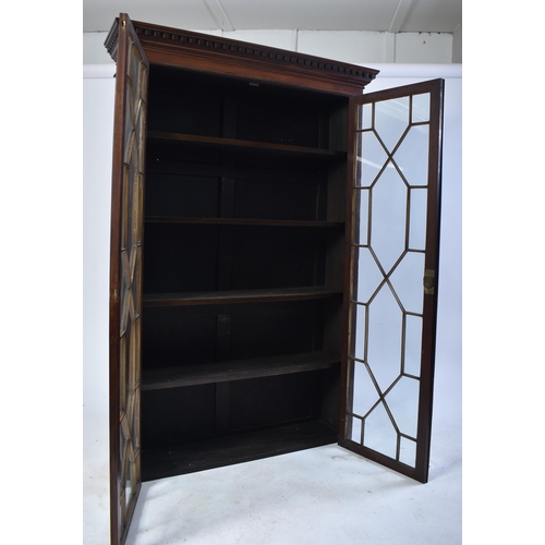 391 - An early 20th century Edwardian mahogany bookcase cabinet in the Chippendale taste. The bookcase hav... 