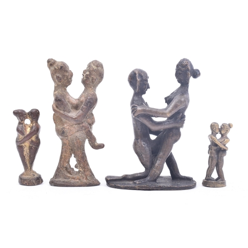 393 - A collection of four 19th century tribal style erotic bronze / iron figurines. The figures depicting... 