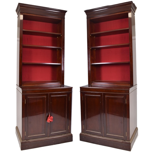 398 - A pair of tall early 20th century Victorian style mahogany bookcase cabinets. Each having a pediment... 