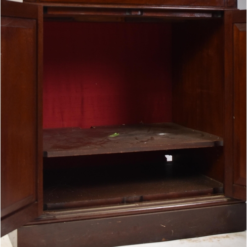 398 - A pair of tall early 20th century Victorian style mahogany bookcase cabinets. Each having a pediment... 