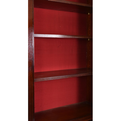 398 - A pair of tall early 20th century Victorian style mahogany bookcase cabinets. Each having a pediment... 