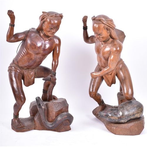 399 - A pair of early 20th century circa 1900s Oriental carved wood figures of tribal hunters with preys. ... 