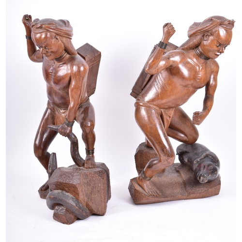 399 - A pair of early 20th century circa 1900s Oriental carved wood figures of tribal hunters with preys. ... 