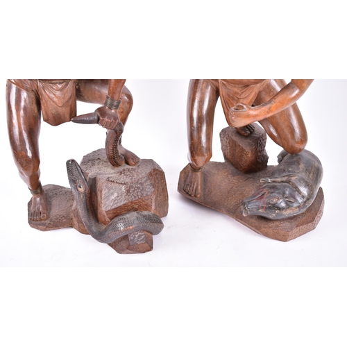 399 - A pair of early 20th century circa 1900s Oriental carved wood figures of tribal hunters with preys. ... 