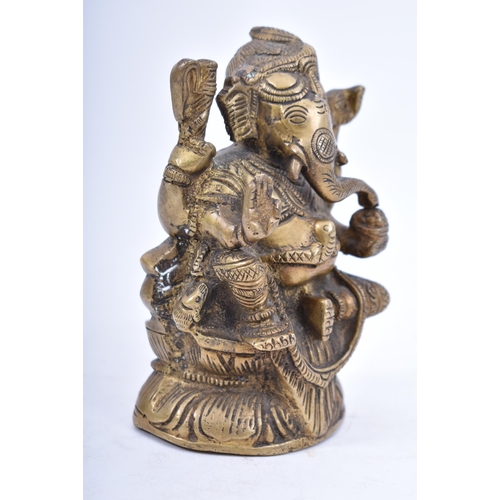 41 - An Indian/Hindi heavy bronze figure of Ganesha/Ganesh. The figurine modelled holding a bowl of sweet... 