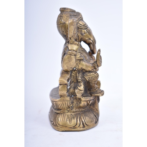 41 - An Indian/Hindi heavy bronze figure of Ganesha/Ganesh. The figurine modelled holding a bowl of sweet... 