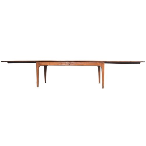 45 - An early 20th century French continental fruitwood refectory farmhouse extending dining table. The t... 