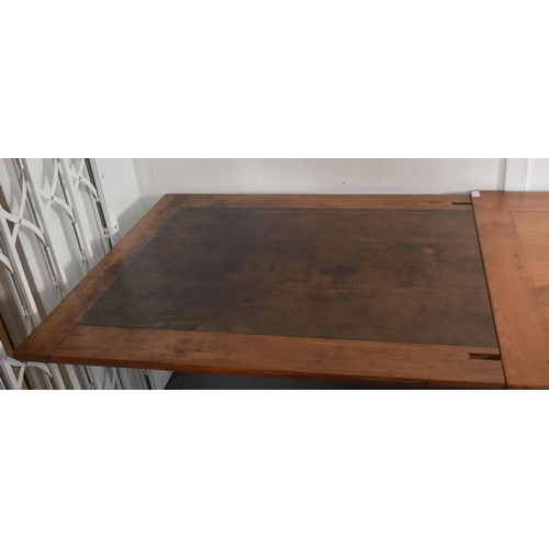 45 - An early 20th century French continental fruitwood refectory farmhouse extending dining table. The t... 