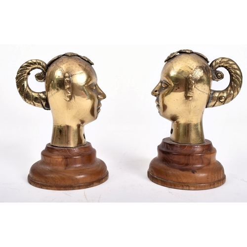 456 - A pair of 20th century Indian Hindu cast brass Gauri / Gowri idol heads on wooden stands. Each head ... 