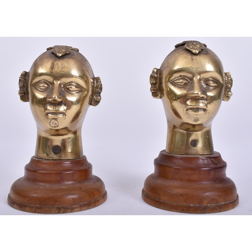 456 - A pair of 20th century Indian Hindu cast brass Gauri / Gowri idol heads on wooden stands. Each head ... 