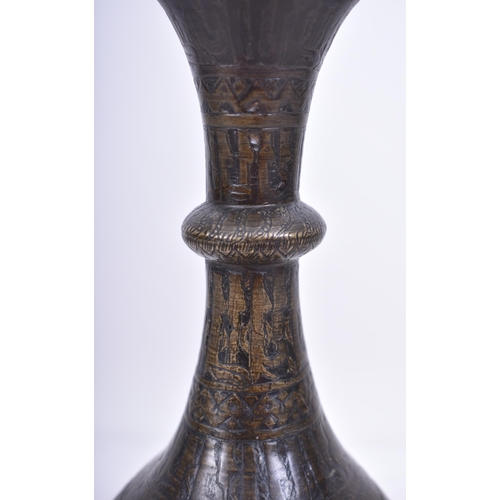 46 - An 18th century Persian Islamic hand cast bronze decorative vase. The vase having a trumpet flared r... 