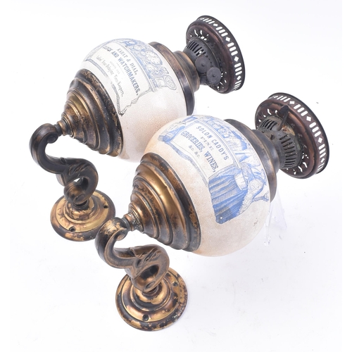 467 - A pair of early 20th century point of sale advertising brass wall oil lamp sconces. Each lamp having... 