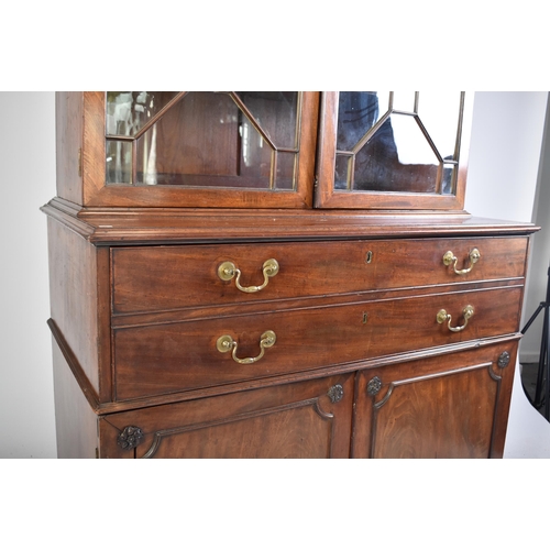 57 - A 19th century George III mahogany secretaire / estate bureau bookcase. Raised on a plinth base with... 