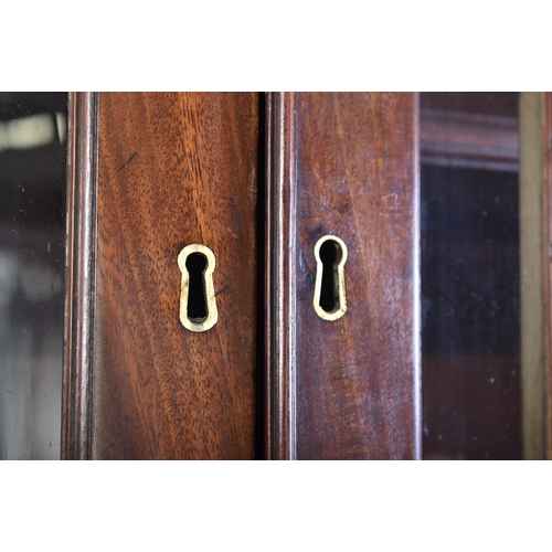 57 - A 19th century George III mahogany secretaire / estate bureau bookcase. Raised on a plinth base with... 