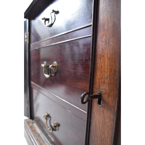 57 - A 19th century George III mahogany secretaire / estate bureau bookcase. Raised on a plinth base with... 