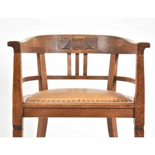 59 - An early 20th century circa 1920s elm wood tub office chair. The chair having a tub shaped back scro... 