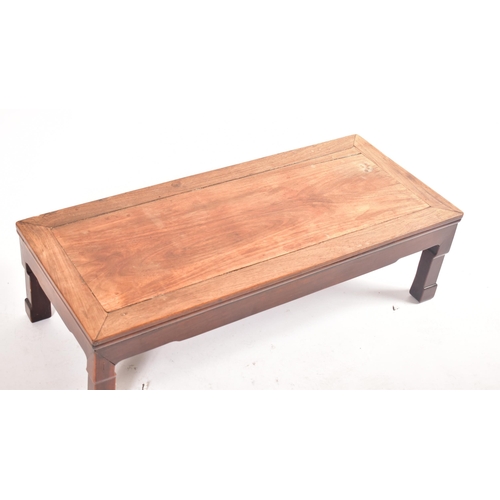 593 - A late 19th century Chinese hardwood low coffee table. The coffee table with panelled top and the le... 