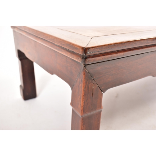 593 - A late 19th century Chinese hardwood low coffee table. The coffee table with panelled top and the le... 