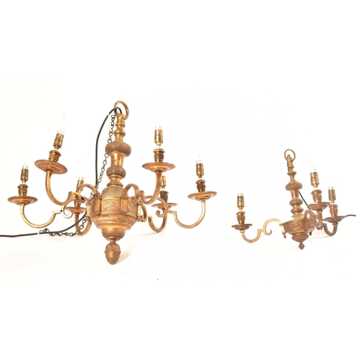 599 - A pair of 20th century Dutch style gilt brass chandelier / light fitting. The larger of the two havi... 