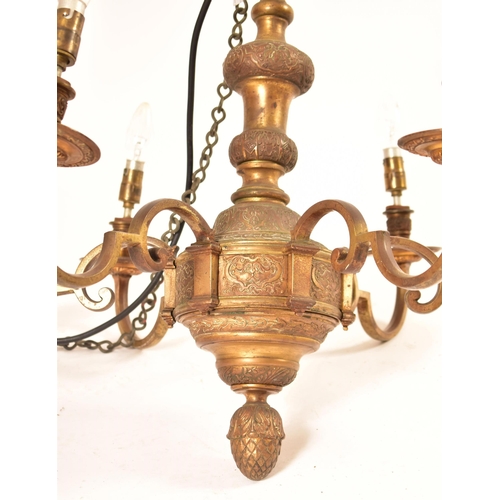 599 - A pair of 20th century Dutch style gilt brass chandelier / light fitting. The larger of the two havi... 