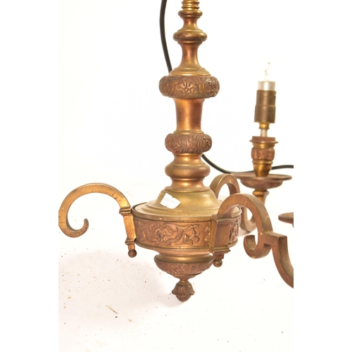 599 - A pair of 20th century Dutch style gilt brass chandelier / light fitting. The larger of the two havi... 