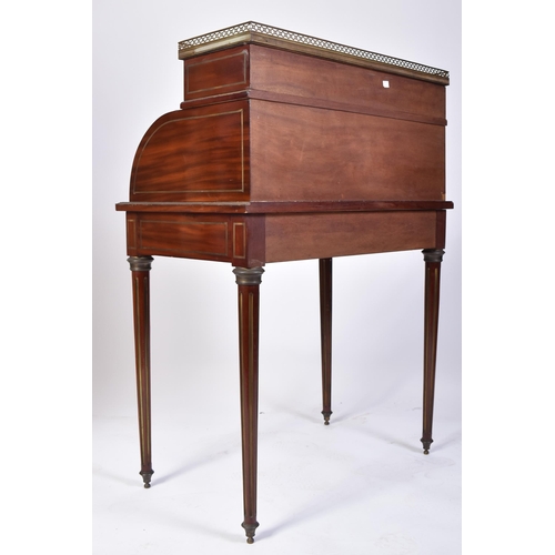 61 - A 19th century French empire mahogany and brass cylinder bureau desk. Raised on reeded tapering legs... 