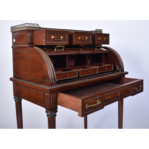 61 - A 19th century French empire mahogany and brass cylinder bureau desk. Raised on reeded tapering legs... 