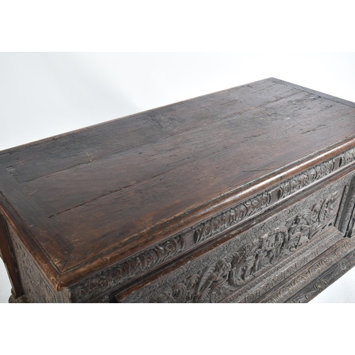 75 - A 17th century carved Italian large Cassone converted to a desk. The heavily carved front panel in r... 