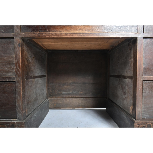 75 - A 17th century carved Italian large Cassone converted to a desk. The heavily carved front panel in r... 