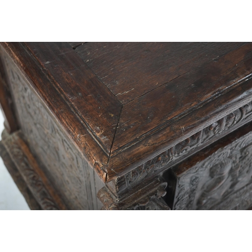 75 - A 17th century carved Italian large Cassone converted to a desk. The heavily carved front panel in r... 