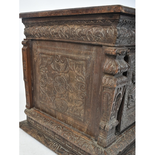 75 - A 17th century carved Italian large Cassone converted to a desk. The heavily carved front panel in r... 