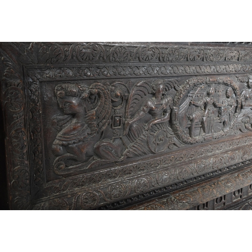 75 - A 17th century carved Italian large Cassone converted to a desk. The heavily carved front panel in r... 