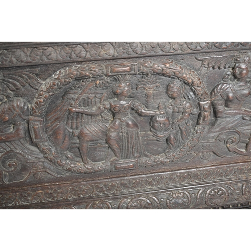 75 - A 17th century carved Italian large Cassone converted to a desk. The heavily carved front panel in r... 