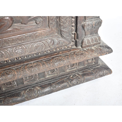 75 - A 17th century carved Italian large Cassone converted to a desk. The heavily carved front panel in r... 